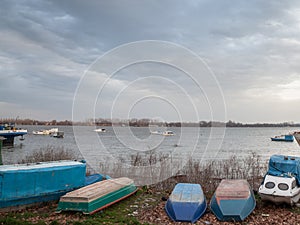 Boats and ships, some fishing ships and old and rusty abandoned boats standing on the riverbanks of river Dabube on Zemunski Kej