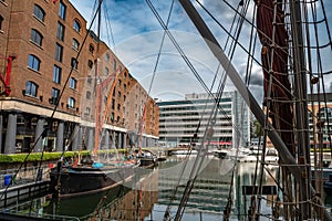 Boats And Ships In St Katharine Docks With Office Buildings And Restaurants In London, UK