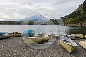 boats at Shoji lake shore with mount Fuji or Fujisan background