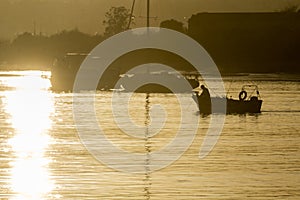 Boats silhouette at sunset, in Quatro Aguas port backgro