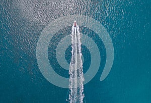 Boats and speedboats on the surface of the sea photo