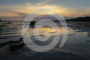 Boats stranded on sand at sunset, Nusa Ceningan, Bali