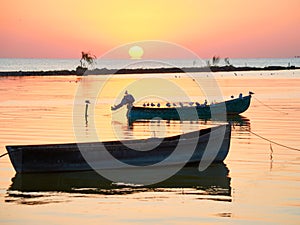 Boats at sunrise on the lake