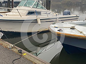 Boats tied up at a dock on a foggy morning