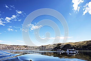 boats with tourists sailing on lake titicaca from puno to the floating islands of the uros, puno peru-october 2021