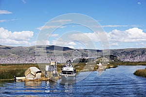 boats with tourists sailing on lake titicaca from puno to the floating islands of the uros, puno peru-october 2021