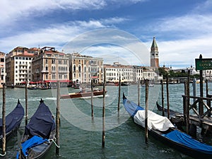 Gondolas parked along the Grand Canal of Venice, Italy.