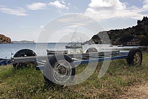 Boats on the trailer in the beautiful beach in the island of Patmos, Greece in summer time