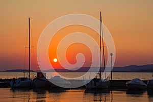 Boats in the Trasimeno lake at sunset. Umbria