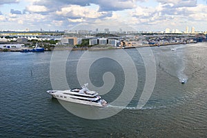 Boats turning in the bay, heading towards the Port of Miami on a summer day with low cloud on the horizon