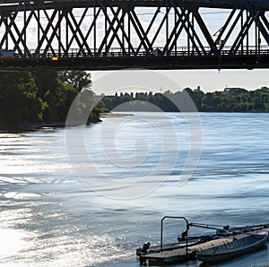 Boats under the iron bridge on the Po river, Cremona - Italy