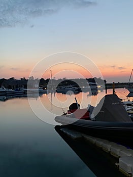 Boats under a red sky reflections