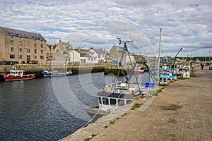 boats are in the water next to houses and buildings near a dock