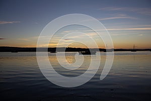 Boats on the water of the river Exe near Lympstone, Devon at dusk