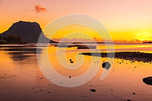 Boats in water at sunset. Le Morn mountain on background in Mauritius