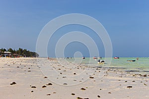 Boats on wide coastline on Zanzibar island. Sailboats on the beach. Tropical resort. Aerial seascape, Africa.