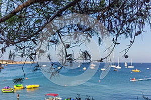 Boats and yachts anchored close to the sea shore in blue lagoon