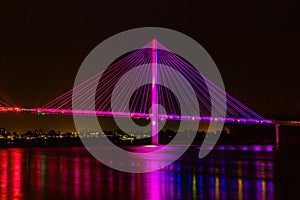 Bob Kerrey cable stayed pedestrian bridge Omaha Nebraska at night with lights reflection in the Missouri river. photo