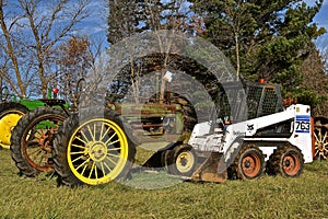 Bobat skid steer pushing an old tractor