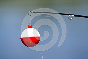 Red and white fishing bobber photo