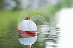 Bobber floating on water with ripples