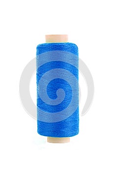 Bobbin of blue thread isolated