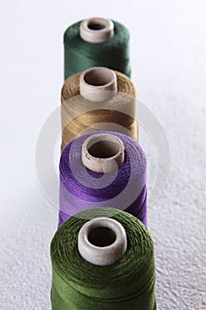 Bobbins with multicolored yarn. Multicolored threads. Yarn. Sewing threads. Type of thread. The texture of multicolored