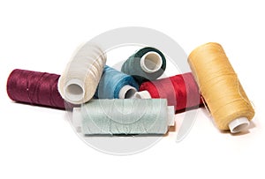 Bobbins of thread on white background