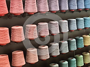 Bobbins with yarn in rows in various colors