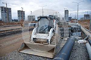 Bobcat skid-steer loader for loading and unloading works on city streets. ÃÂ¡ompact construction equipment for work in limited