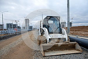 Bobcat skid-steer loader for loading and unloading works on city streets. ÃÂ¡ompact construction equipment