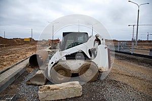 Bobcat skid-steer loader for loading and unloading works on city streets. ÃÂ¡ompact construction equipment for work in limited