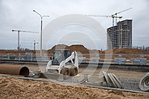 Bobcat skid-steer loader for loading and unloading works on city streets. ÃÂ¡ompact construction equipment for work in limited