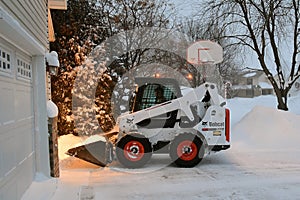 Bobcat skid steer removing snow