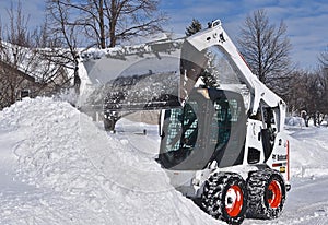 Bobcat skid steer removing snow