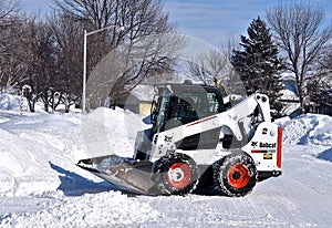 Bobcat skid steer removing snow