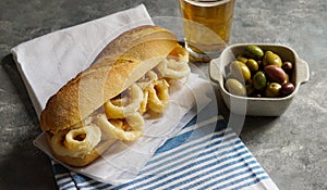 bocadillo con calamares or squid sandwich with beer photo