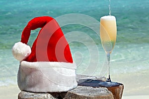 Bocal of champagne is on a beach photo