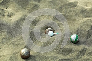 Bocce sport balls on sandy beach