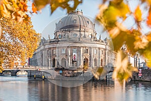 Bode Museum in autumn vibes with leaves and river spree with a bridge