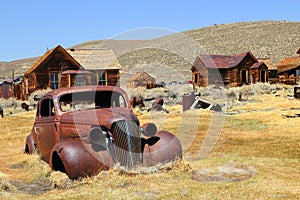 Bodie Ghost Town, Arrested Decay of old car and houses at Bodie State Historic Park, California, USA