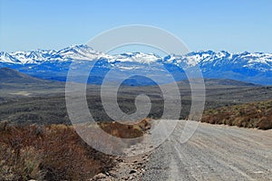 Bodie Road in Dry Eastern Sierra Foothills with Snow-covered Sierra Nevada, California, USA