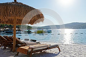 Bodrum, Turkey - August, 2020 Hotel Lujo, Beautiful Aegean sea turquoise blue color and palm trees on the beach. Sun photo