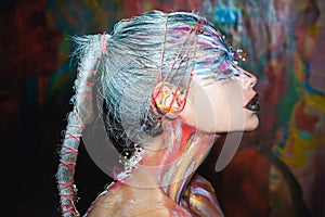 Body art. Young woman muse with creative body art and hairdo. Beautiful woman with art makeup. Abstract colourful art