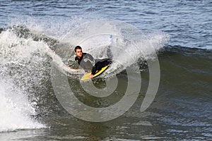 Body boarder riding wave