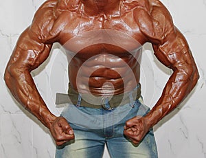 Body builder poses in the most muscular pose