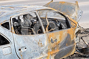 Body of the burnt car in the street