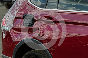 The body of the car is damaged as a result of an accident. High speed head on a car  traffic accident. Dents on the car body after