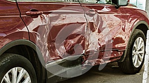 The body of the car is damaged as a result of an accident. High speed head on a car  traffic accident. Dents on the car body after