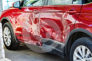 The body of the car is damaged as a result of an accident. High speed head on a car  traffic accident. Dents on the car body after